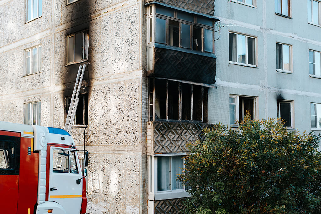 disaster-destruction-fire-multistorey-apartment-building-outside-black-burnt-balcony-windows