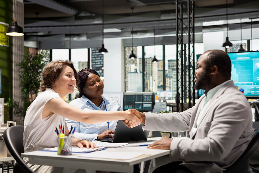 handshake-hr-manager-candidate-filling-new-position-legal-terms-paperwork