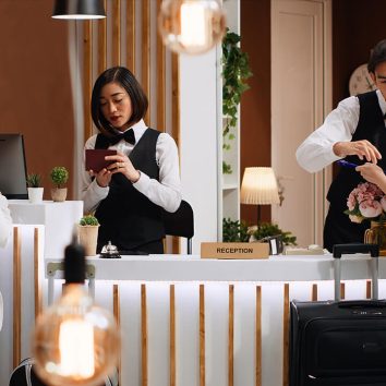 tourists-going-through-check-process-hotel-reception-desk